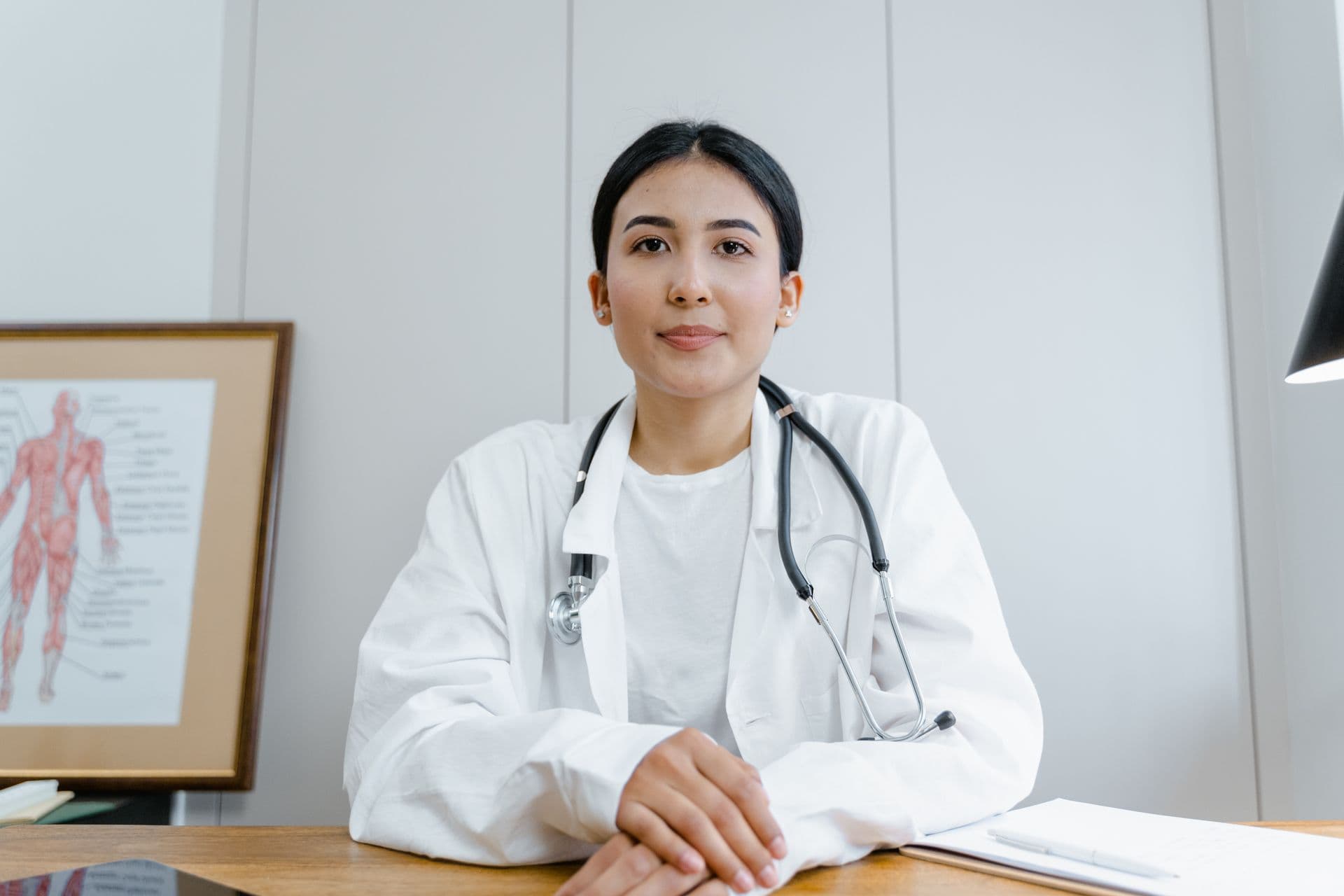 Clinician reviewing specimens with laboratory microscope and clinical equipment